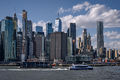 A Brooklyn-bound New York Ferry passes a barge on the East River with the view of Lower Manhattan in the background-DRFlickr.jpg